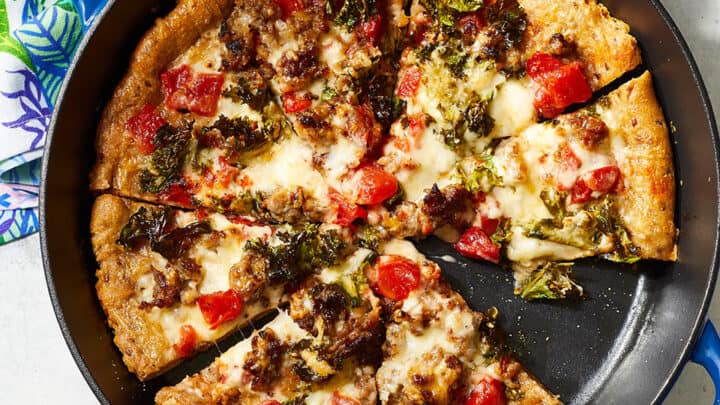 cast iron skillet pizza with white and blue background