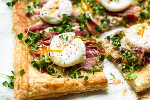 Closeup view of poached egg on a breakfast tart with bacon