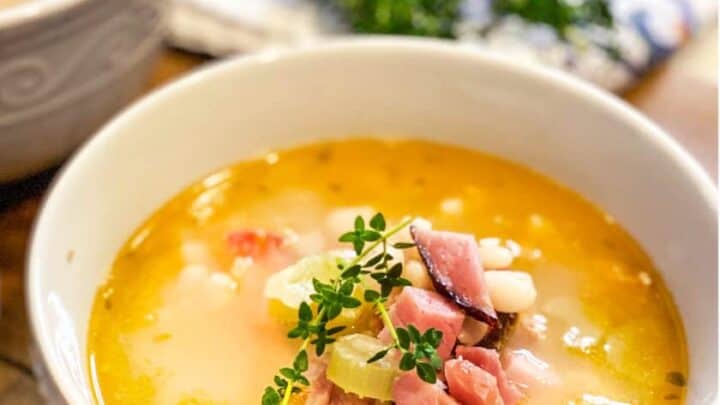 Ham Bone Soup in a White Bowl on a Wood Serving Board