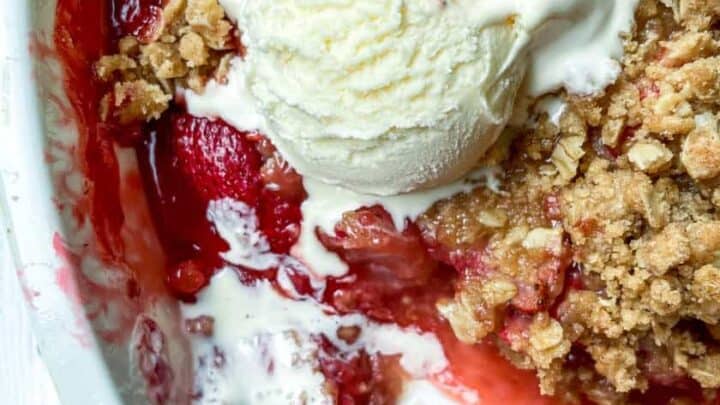 Closeup view of Strawberry Crisp with vanilla ice cream.
