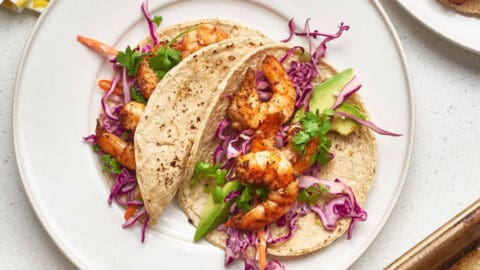 Sheet Pan Shrimp Tacos on a White Plate with Cabbage Slaw