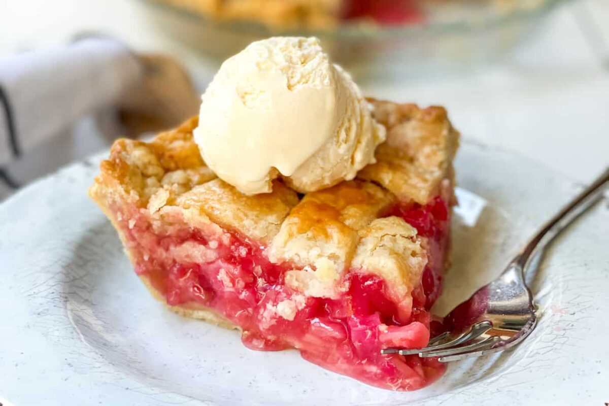Slice of Rhubarb Pie with Vanilla Ice Cream on top.
