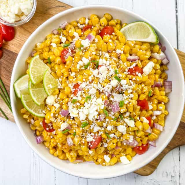 Grilled Corn Salad in a White Bowl with Tomatoes and Feta