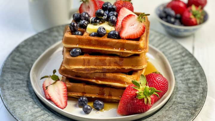 Closeup of Whole Wheat Waffles Stacked with Strawberries and Blueberries