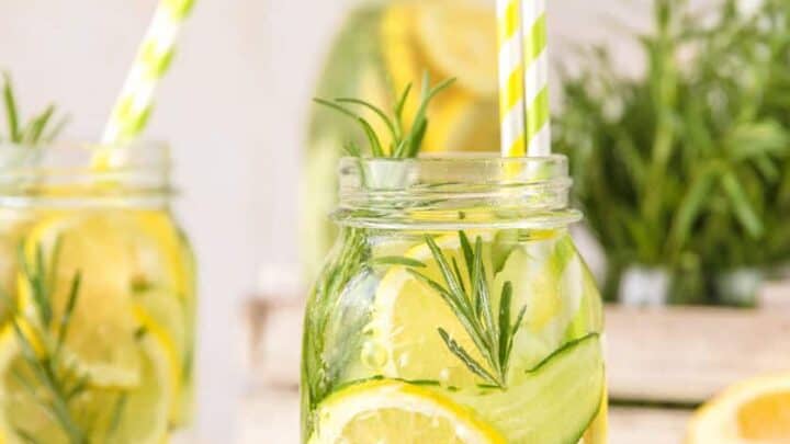 Herb Lemon Water in glass mason jars with yellow straws