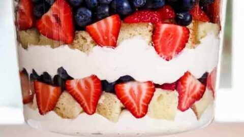 Closeup side view of Layered Berry Trifle Recipe in a glass trifle dish.