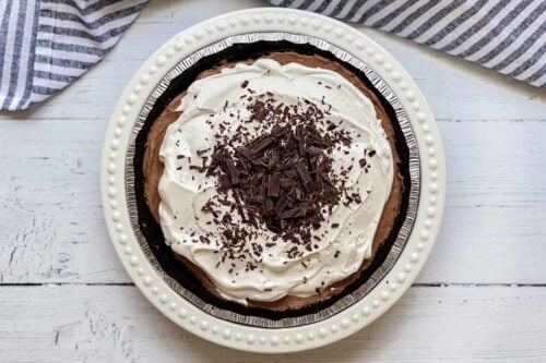 Top view of chocolate pie with cream and chocolate shavings