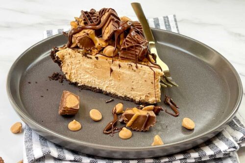 Slice of No Bake Peanut Butter Pie on a dark grey plate.