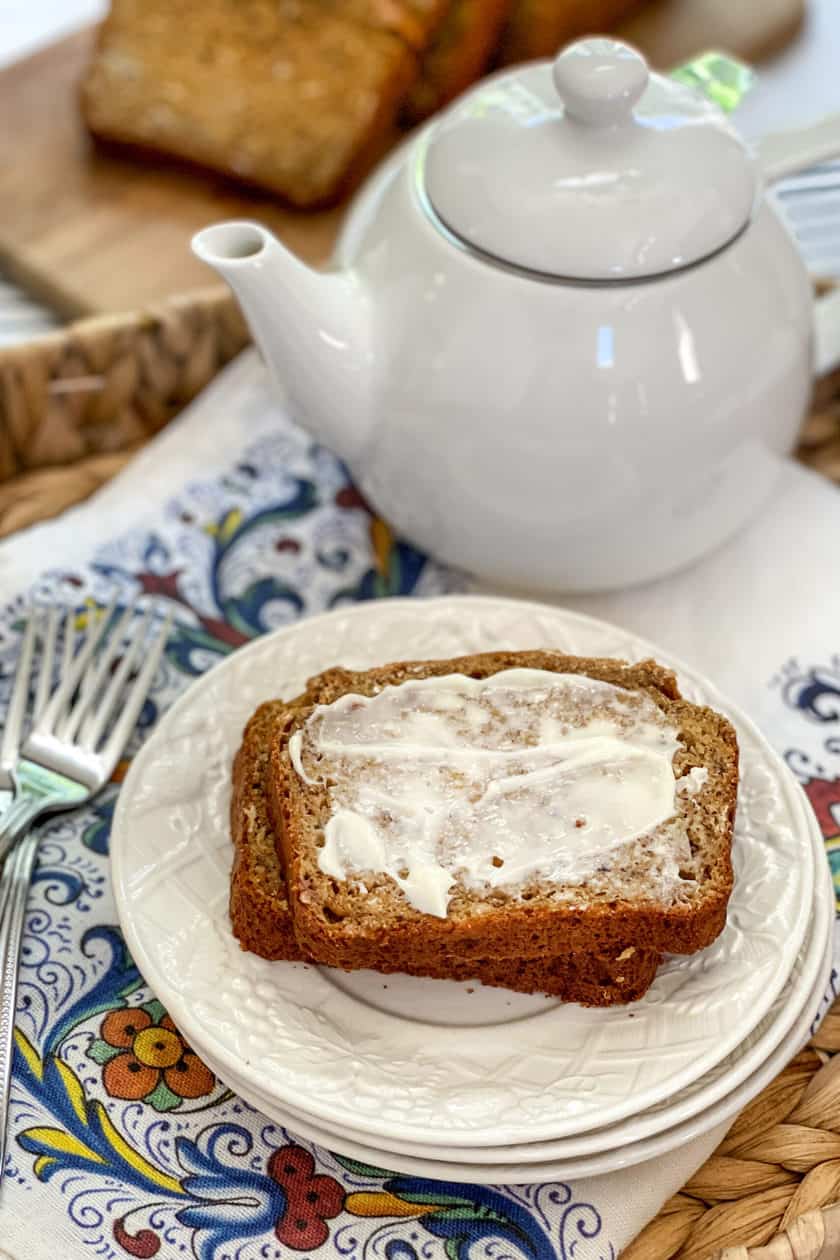 Buttered and sliced Banana Oat Bread with tea