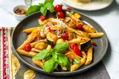 Zucchini Pasta with fresh basil on a grey plate