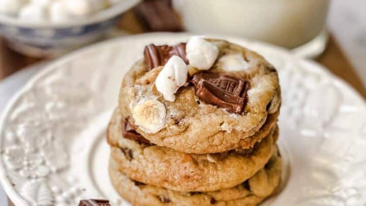 Closeup side view of S'mores Cookies stacked on a white plate