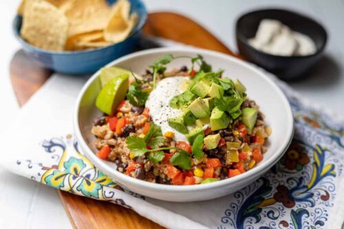 Bowl of Slow Cooker Turkey Chili in a white bowl with avocados