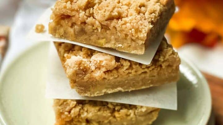 Triple stack of Apple Pie Bars on parchment paper