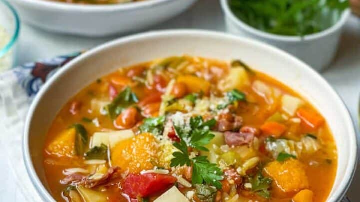 Closeup view of bowls of Minestrone Soup with fresh parsley