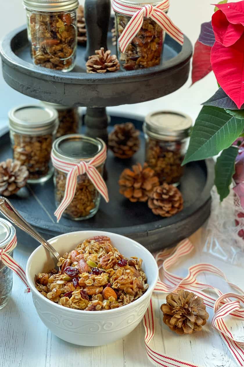 Bowl of Christmas Granola with mason jars ready to gift