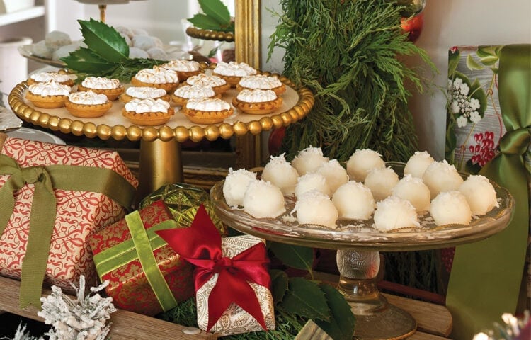 Sidebar serving for Christmas Tea with various sizes of cake stands featuring Christmas teatime treats and wrapped packages.