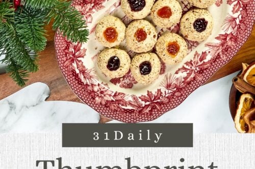 Pinterest Pin for Christmas Thumbprint Cookies are buttery cookies filled with jam and rolled in finely chopped almonds. A classic Christmas cookie perfect for parties, cookie platters, or Holiday cookie exchanges.