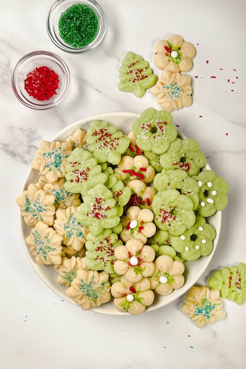 Vertical top view of a spritz cookies on a white platter