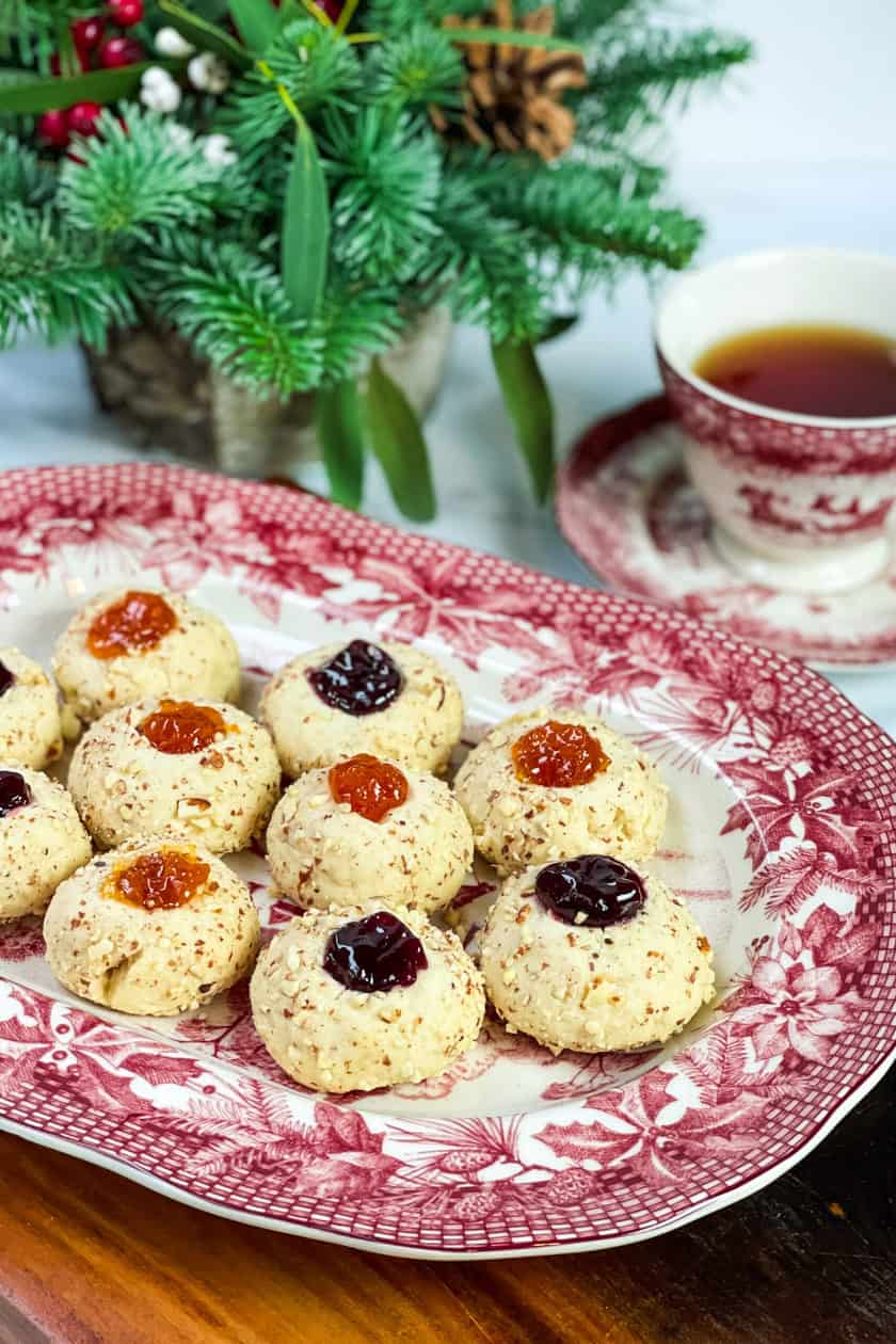 Side view of red and white platter filled with Christmas Thumbprint Cookies