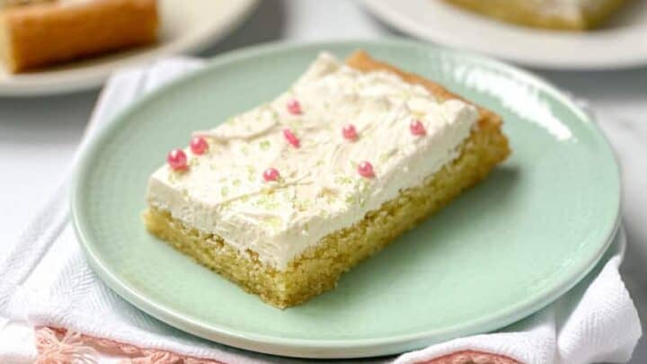 Closeup view of Sugar Cookie Bars on plates with Buttercream Frosting