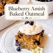 A slice of blueberry Amish baked oatmeal topped with whipped cream and blueberries sits on a plate, while a dish of blueberry Amish baked oatmeal and a bowl of fresh blueberries are displayed in the background.