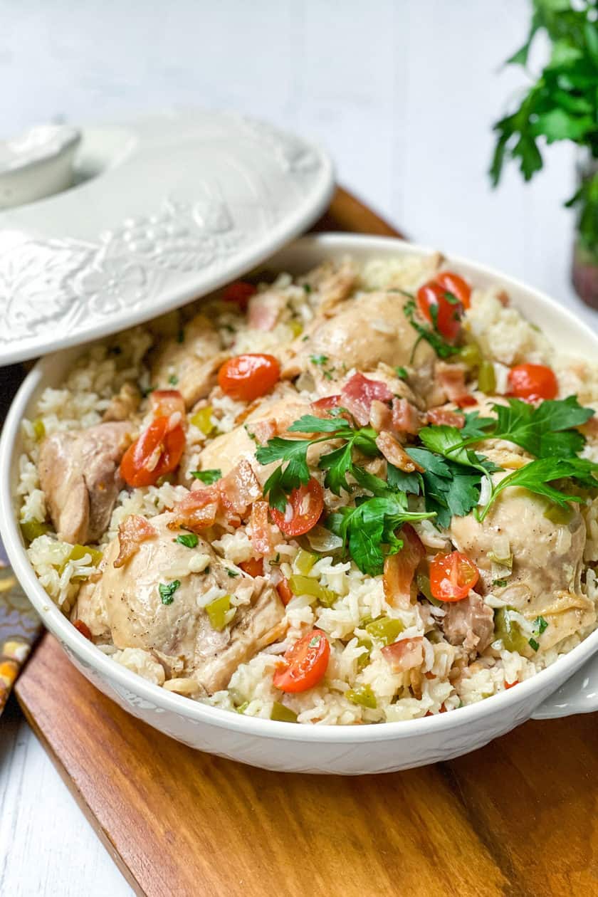 Close up view of Chicken Perloo with fresh parsley in a covered casserole dish