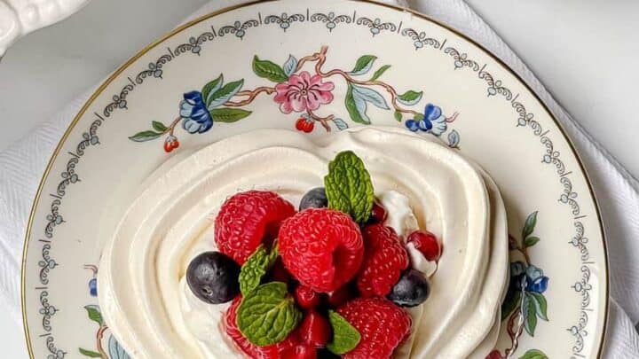 Top view of Heart Shaped Pavlova with fresh fruit and mint leaves