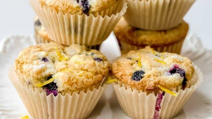 Lemon Blueberry Muffins stacked on a scalloped stand