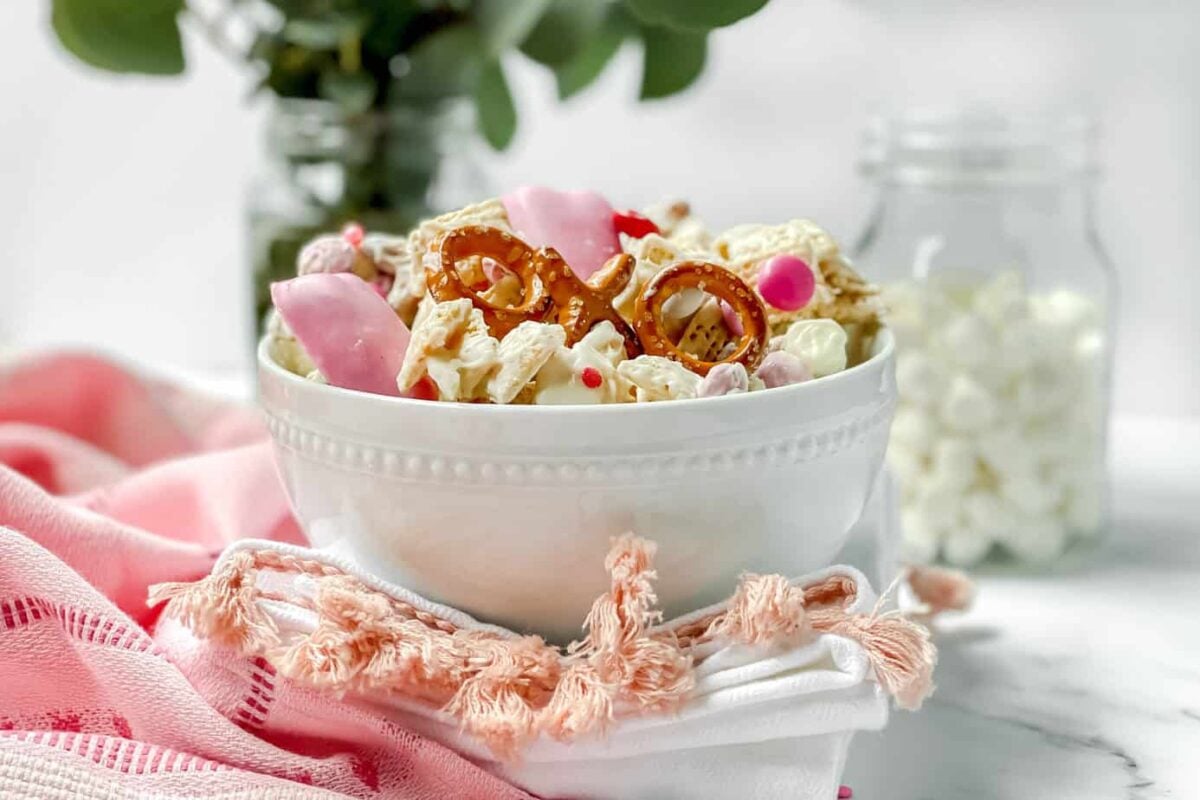 Valentine's Day Crack in a white bowl with pretzels, Chex cereal and M&Ms