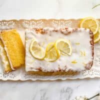 Top view of sliced Lemon Drizzle Cake with lemon slices