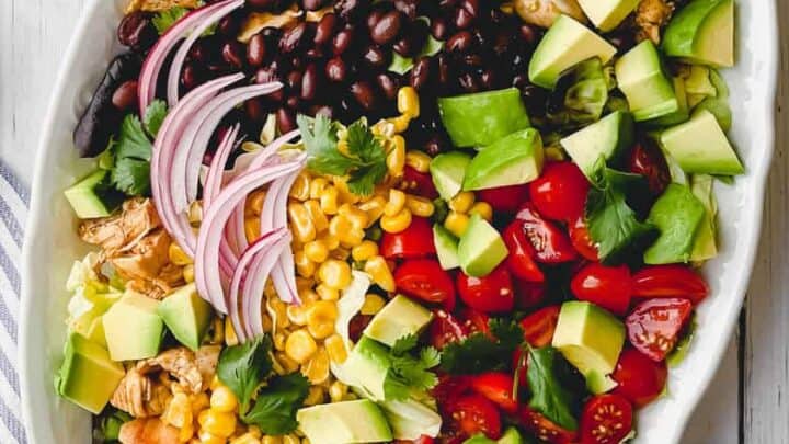 Top view of Chicken Taco Salad with corn, tomatoes and avocados