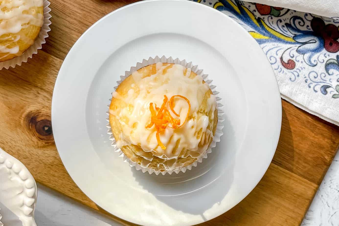 Top view of Orange Yogurt Muffins with glaze and orange zest