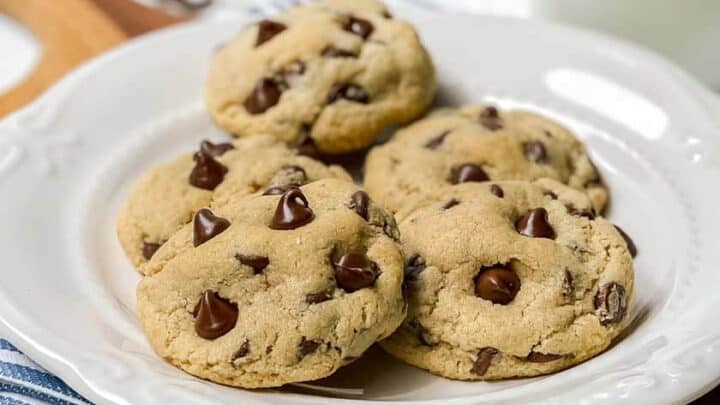 Vertical view of Almond Flour Chocolate Chip Cookies on a wooden board with milk
