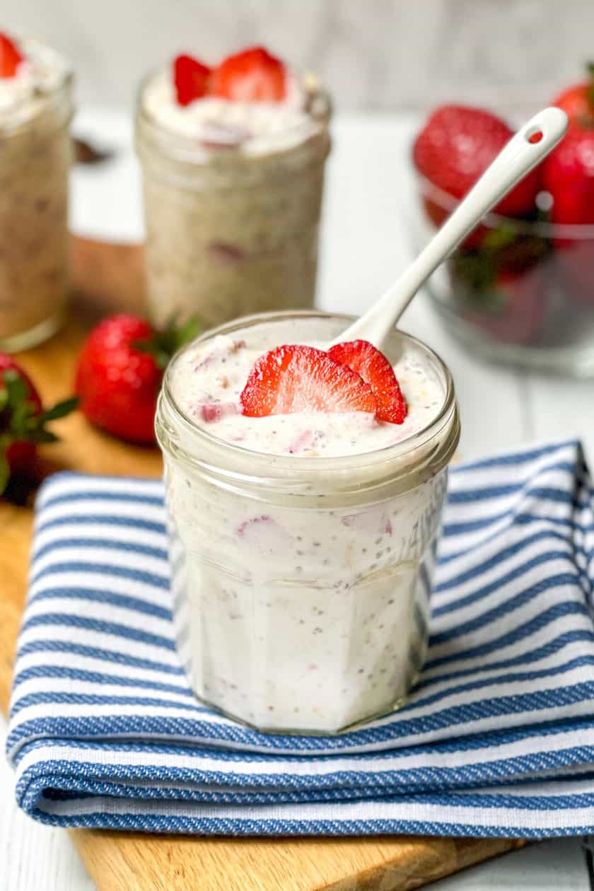 Top view of Strawberry Overnight Oats with slices of fresh strawberries in a lidded glass jar