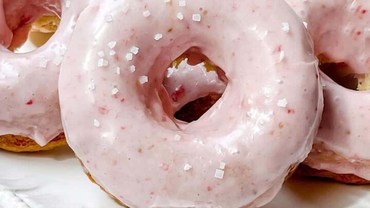 Closeup view of Strawberry Baked Donuts on a White Stand