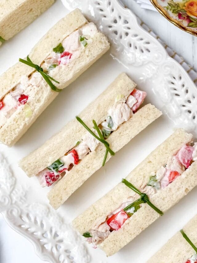 Closeup view of Strawberry Chicken Salad Tea Sandwiches tied with chive ribbon