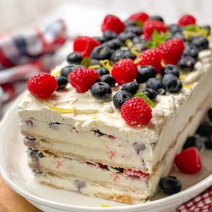 Sliced Icebox Cake topped with fresh summer berries