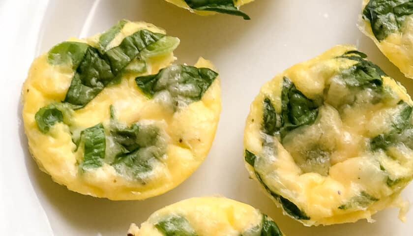Closeup view of Egg Bites with spinach on a white plate