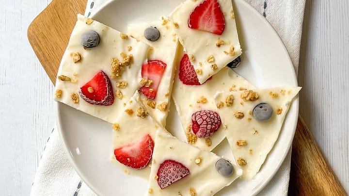 Top view of pieces of Frozen Yogurt Bark on a white plate