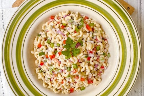 Top view of classic Macaroni Salad in large serving bowl with fresh parsley