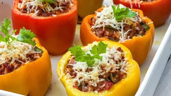 Side view of baked Stuffed Peppers with sprigs of fresh parsley