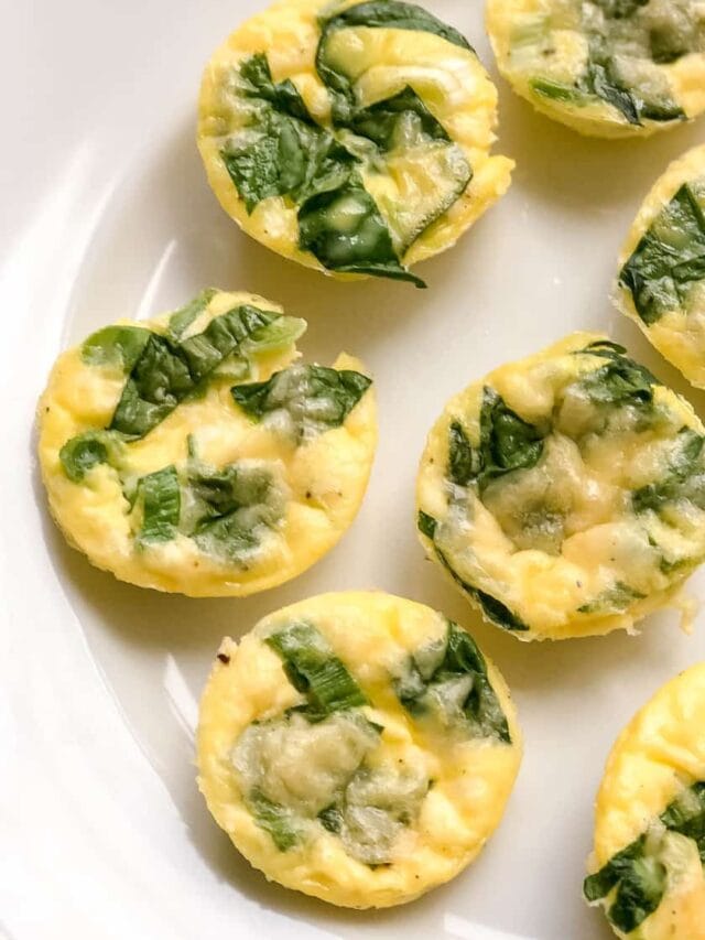 Closeup view of Egg Bites with spinach on a white plate