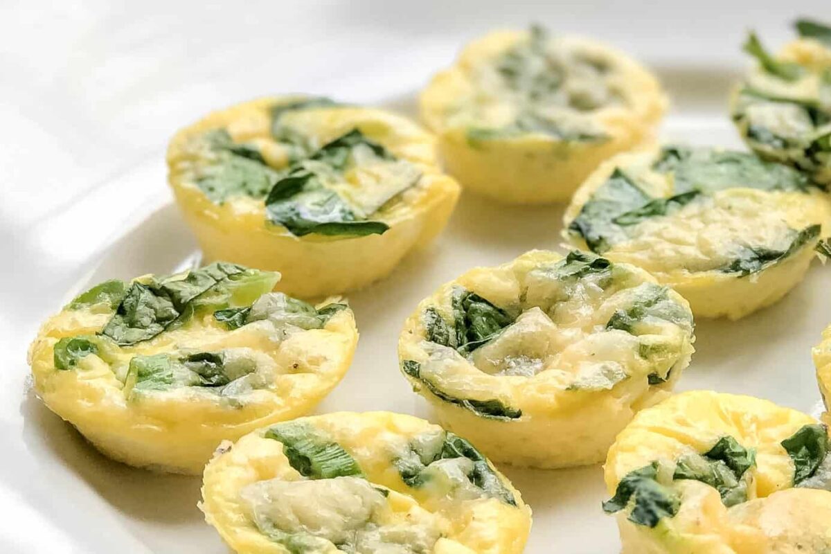 Closeup side view of healthy Egg Bites with fresh vegetables and herbs
