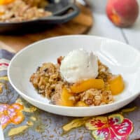 Bowl of Peach Crisp with Vanilla Ice Cream on top