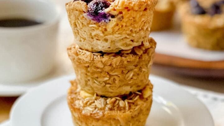 Stack of 3 Baked Oatmeal Cups on a white plate with more in the background