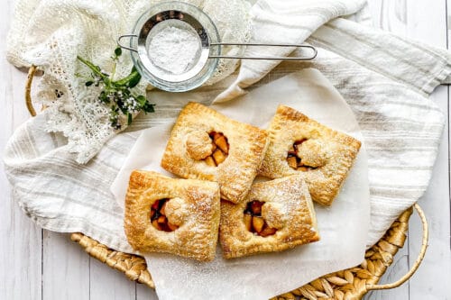Top view of French Apple Hand Pies in a woven basket