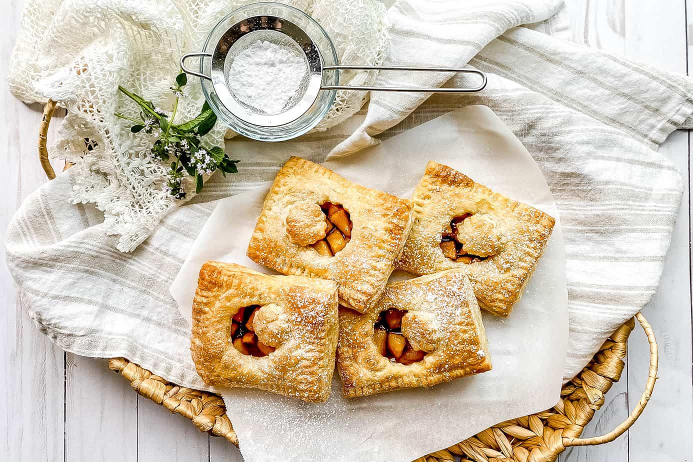 Top view of French Apple Hand Pies in a woven basket