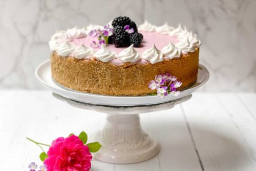 Blackberry No Bake Cheesecake with fresh blackberries on a white cake stand