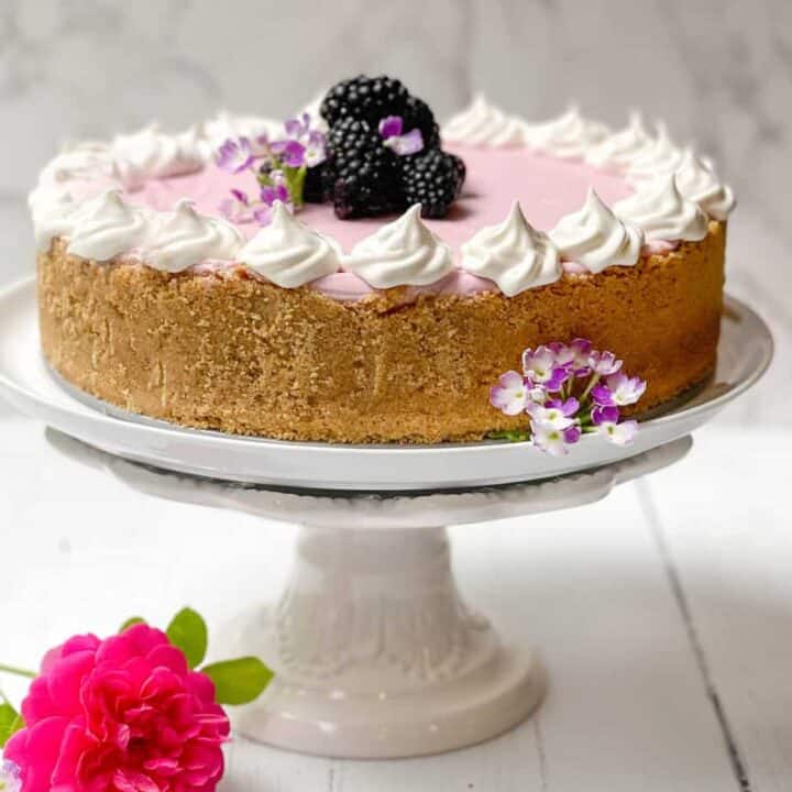Blackberry No Bake Cheesecake with fresh blackberries on a white cake stand