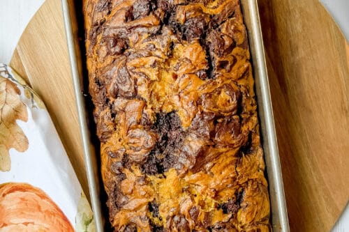 Top view baked Chocolate Swirl Pumpkin Bread in metal loaf pan